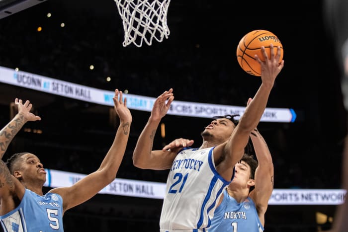 Dec 16, 2023; Atlanta, Georgia, USA; Kentucky Wildcats guard D.J. Wagner (21) attempts layup shot against North Carolina Tar Heels forward Armando Bacot (5) and North Carolina Tar Heels forward Zayden High (1) during the first half at State Farm Arena. Mandatory Credit: Jordan Godfree-USA TODAY Sports